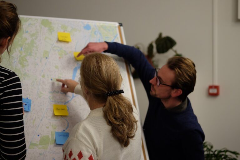 Mensen bepalen meetlocaties op een kaart van Haarlem.